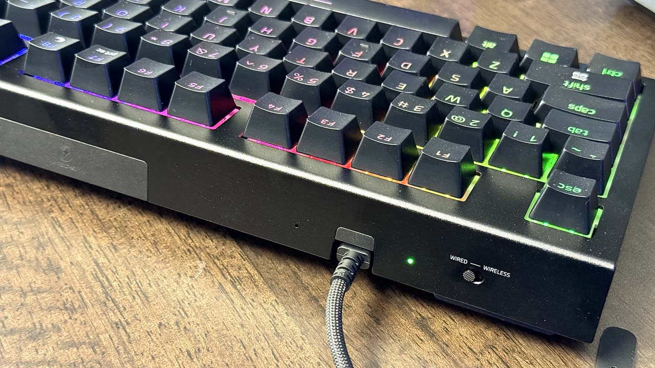 Vue latérale du Razer BlackWidow V4 TKL HyperSpeed avec câble branché et bouton de bascule filaire/sans fil